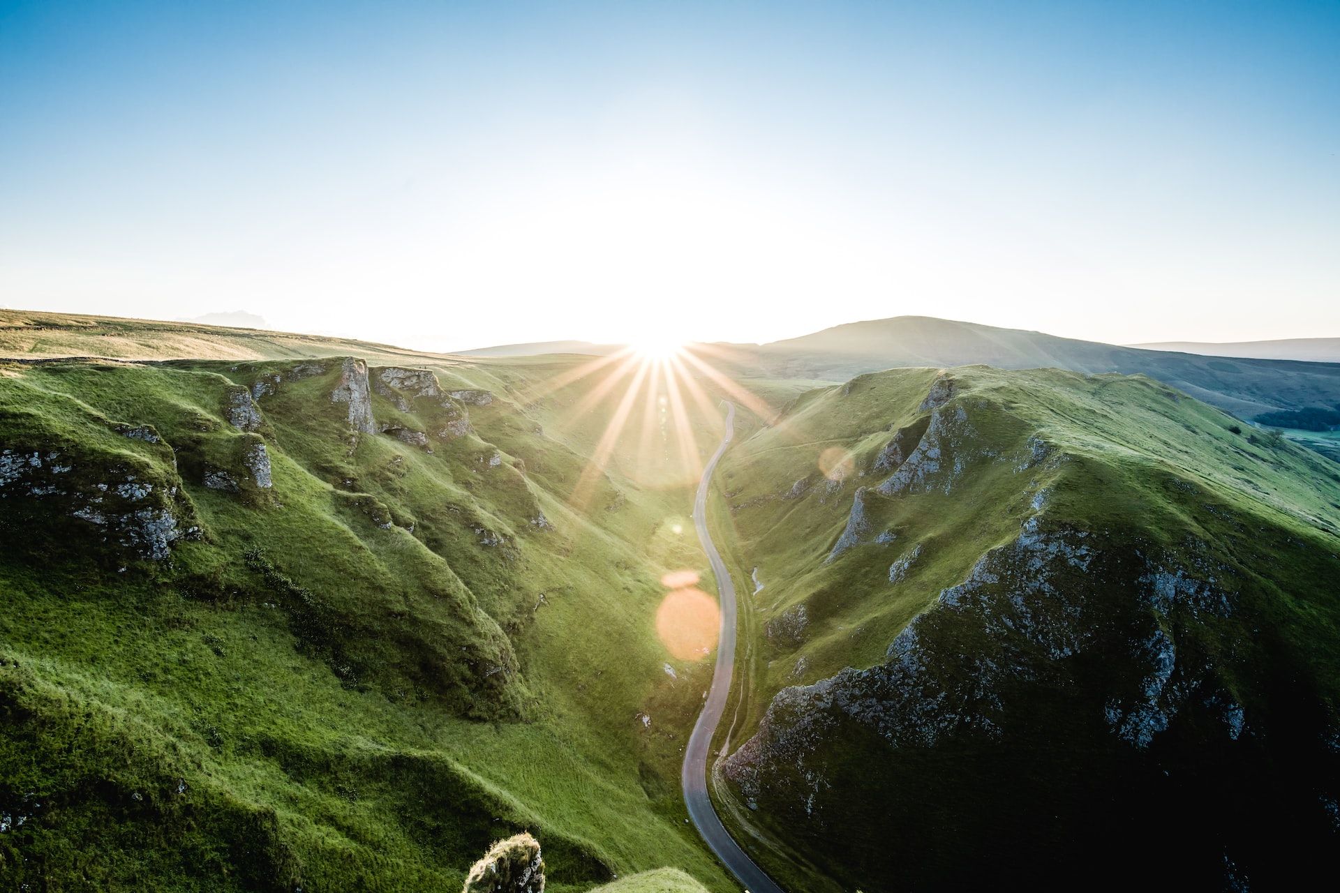 A photograph of a lush and green sunlit valley